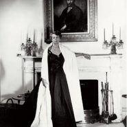 Eleanor Roosevelt as First Lady, standing before a portrait of her paternal grandfather, a family role model for his social welfare work